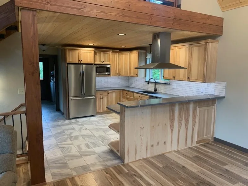 Hickory kitchen remodel with dark countertops and tile floor