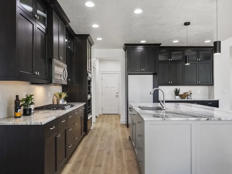 Two-tone kitchen remodel with dark cabinets and gray island