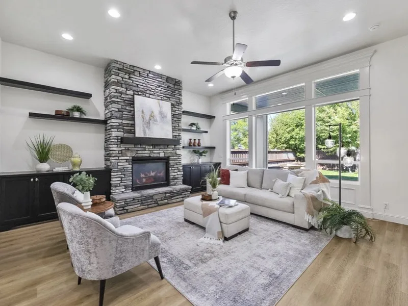 Remodeled living room with floor-to-ceiling stone fireplace and built-ins