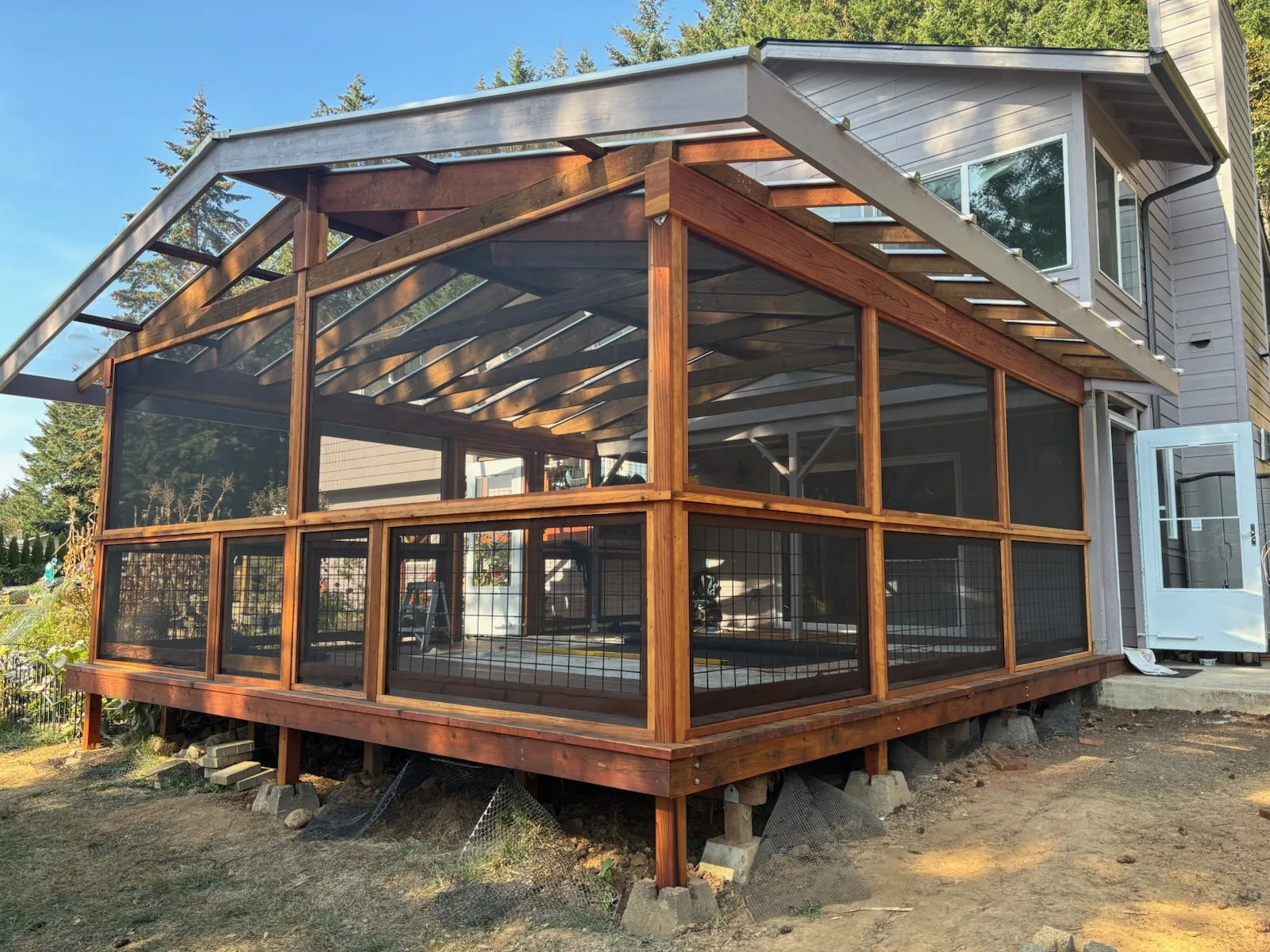 Finished screened porch addition with covered roof and hog-wire railing