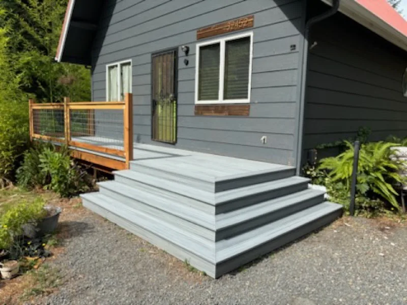 After: the same home restored with a new composite deck and steps